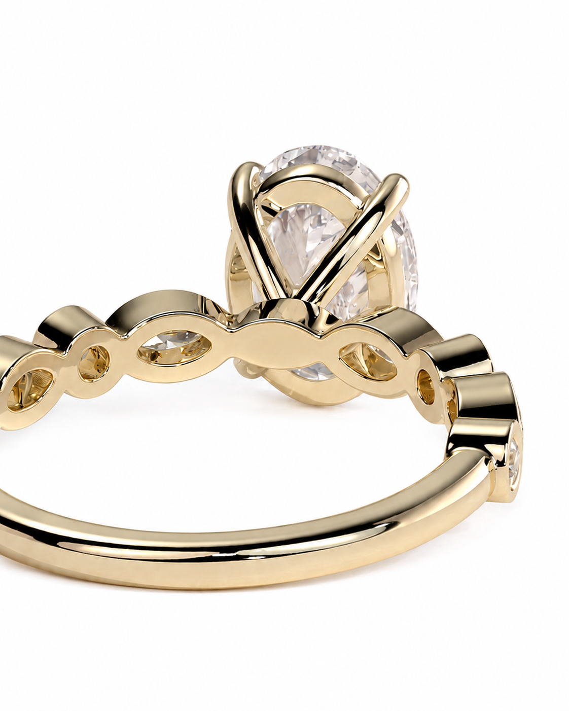 color_10K_YG, color_14K_YG &&A close-up of a gold ring featuring a large oval clear gemstone in a prong setting, with a decorative band containing smaller inset stones, shown on a white background.