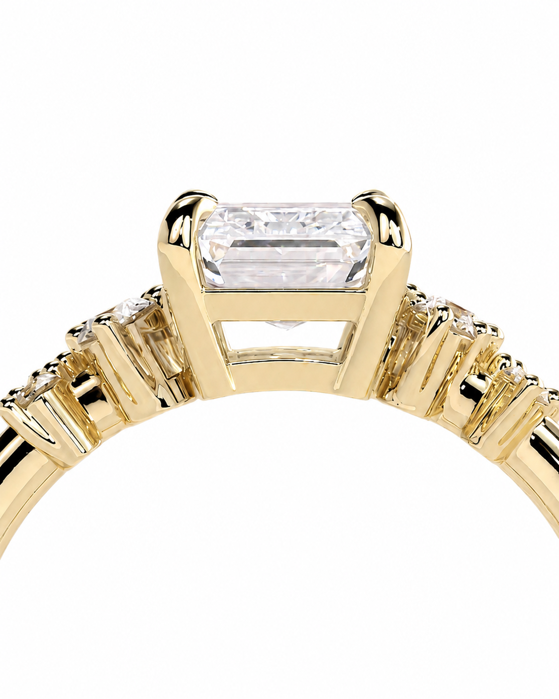 color_10K_YG, color_14K_YG &&A close-up of a yellow gold ring featuring a rectangular baguette-cut clear center stone in a prong setting, with smaller side stones along the band, shown against a plain white background.