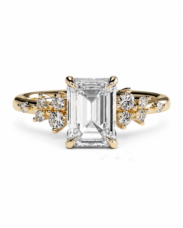color_10K_YG, color_14K_YG &&A yellow gold ring featuring a large rectangular emerald-cut clear center stone and small clear accent stones on the shoulders, set against a plain white background.