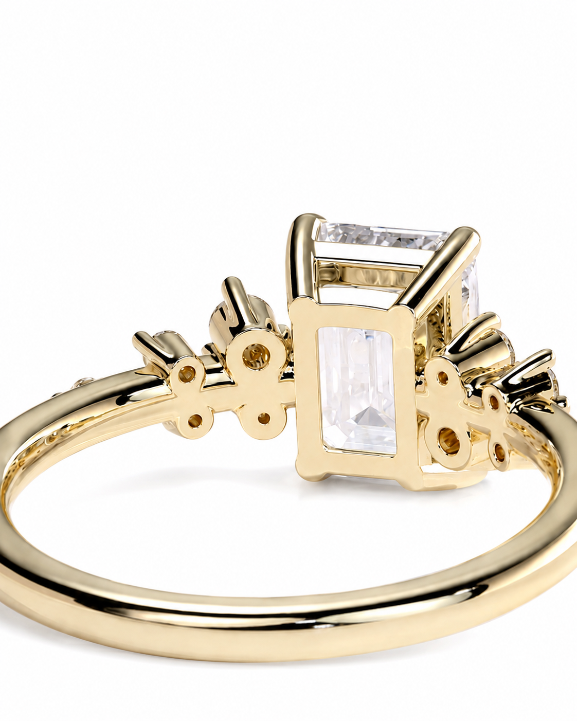 color_10K_YG, color_14K_YG &&A gold ring featuring a large rectangular clear gemstone in a decorative setting with smaller accent stones on the band, shown on a plain white background.