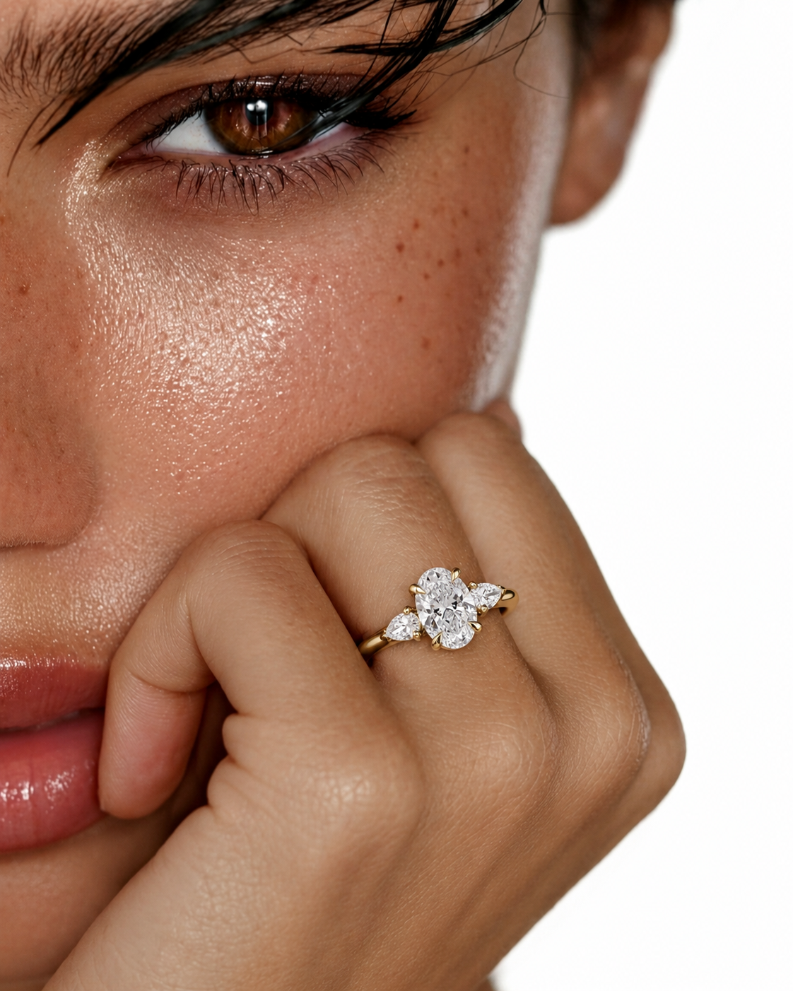 color_10K_YG, color_14K_YG &&
A close-up lifestyle shot of a model wearing a gold ring with a diamond cluster on her finger, set against a clean white background.