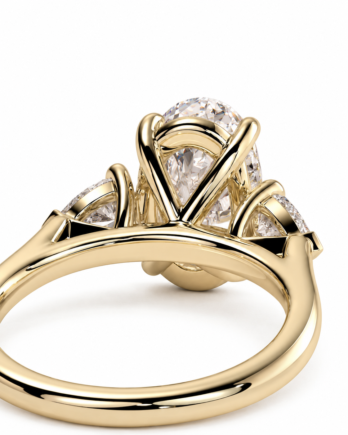 color_10K_YG, color_14K_YG &&
A close-up shot of a yellow gold ring with a large pear-cut clear center stone and smaller side stones, set against a plain white background.