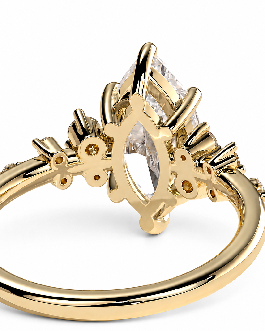 color_10K_YG, color_14K_YG &&A close-up of a yellow gold ring featuring a marquise-cut clear gemstone in an ornate setting with small accent stones on a white background.