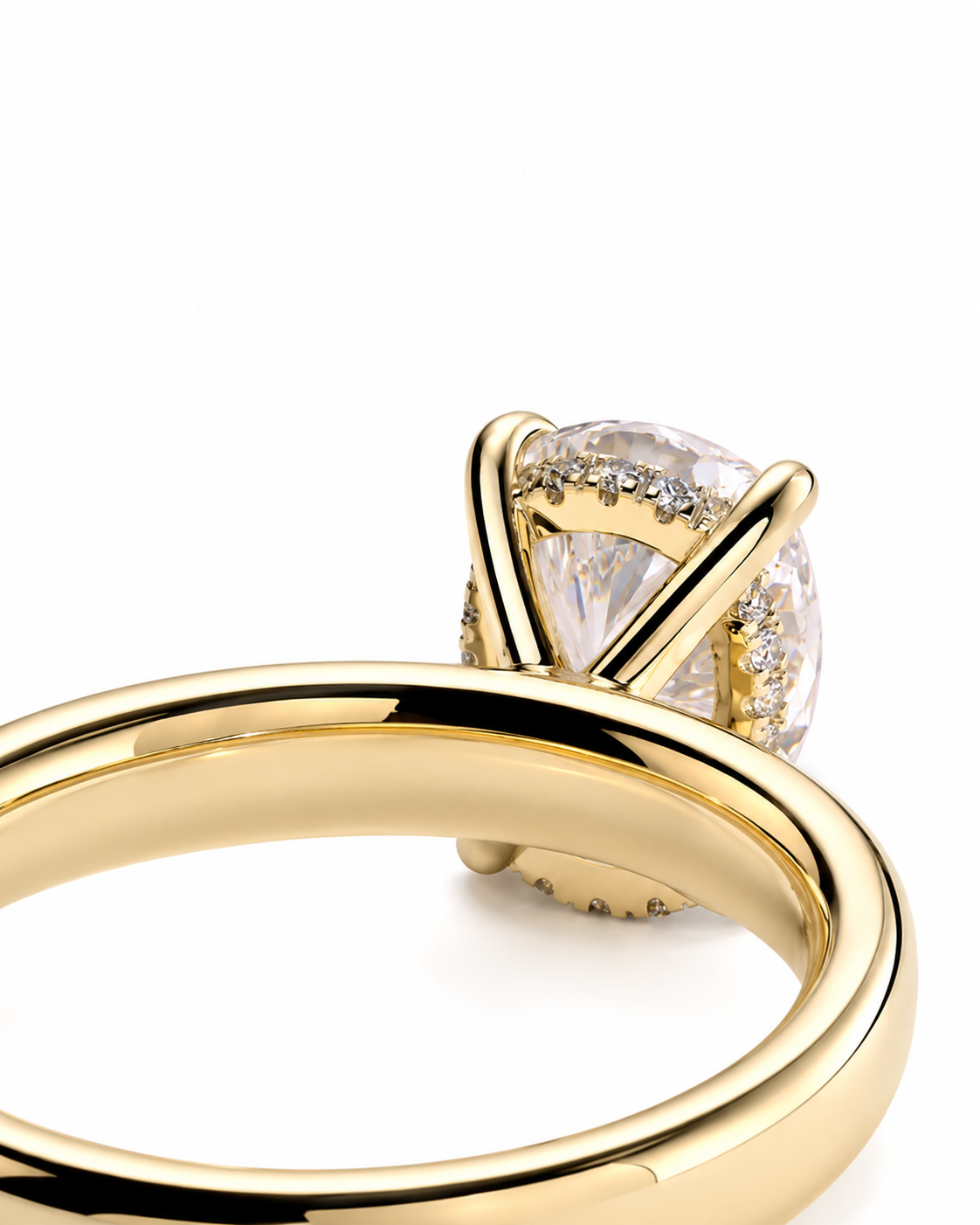 color_10K_YG, color_14K_YG &&A close-up of a yellow gold ring featuring a large heart-shaped clear gemstone in a prong setting, with three smaller round diamonds lined up beneath the center stone. The polished gold band curves upward against a plain white background.