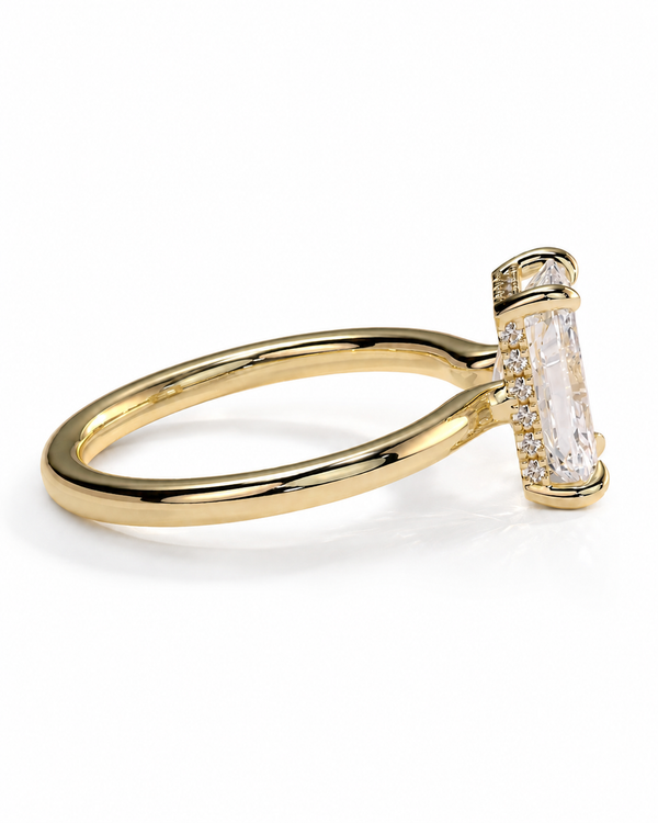 color_10K_YG, color_14K_YG &&A yellow gold ring featuring a large rectangular clear baguette-cut center stone in a prong setting, accented by small pavé diamonds along the shank, shown on a clean white background.