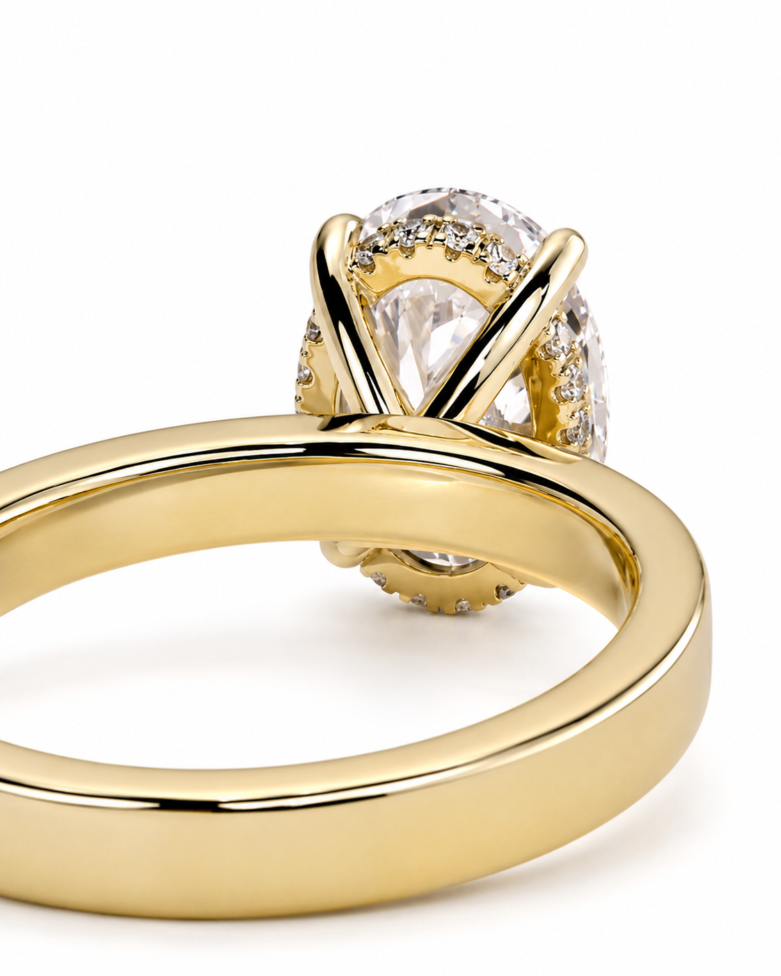 color_10K_YG, color_14K_YG &&A close-up of a gold ring featuring a large oval clear gemstone surrounded by small pavé-set clear stones, on a plain white background.