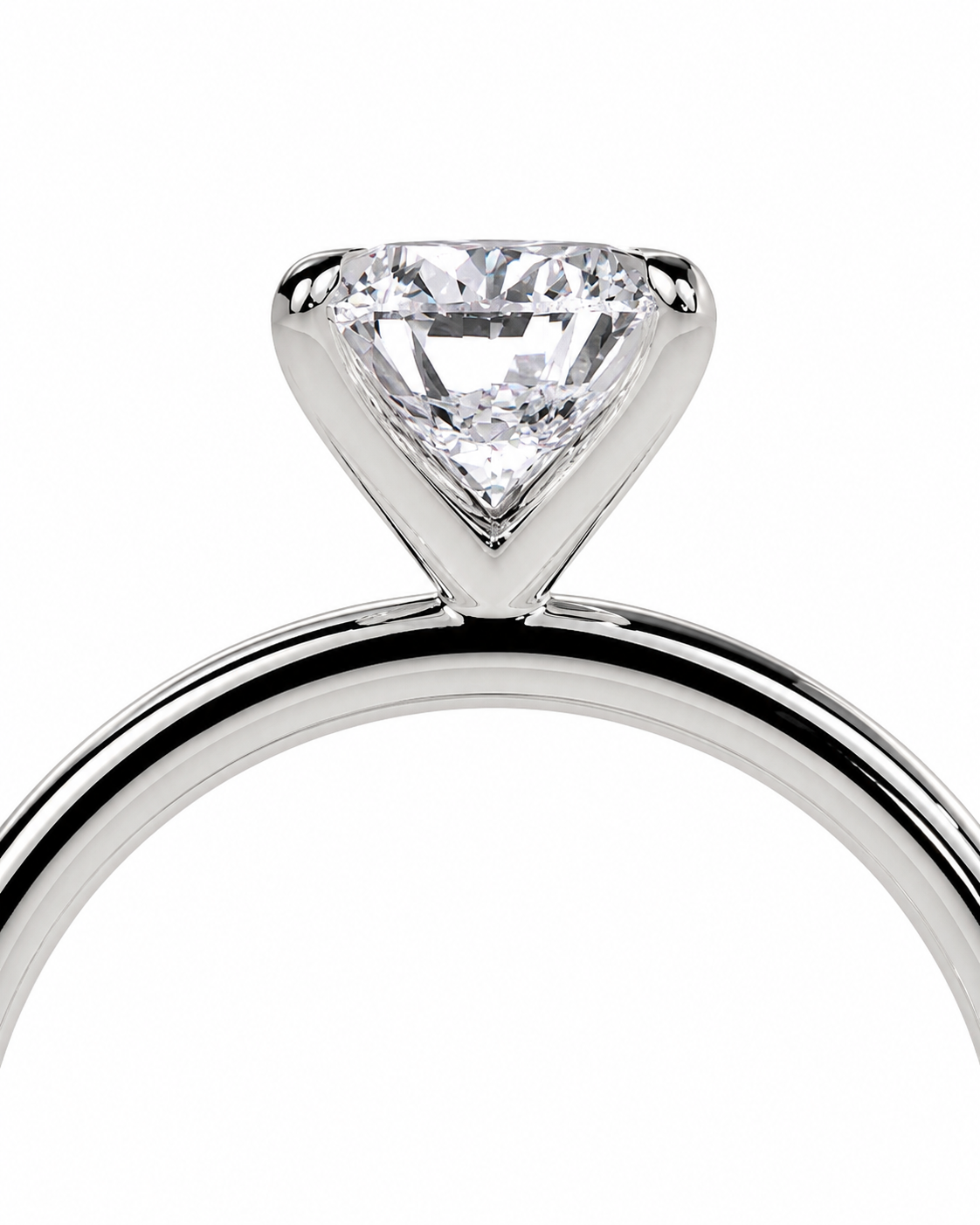 color_925_SIL,color_935_ARG,color_10K_WG, color_14K_WG &&
A close-up studio shot of a solitaire engagement ring featuring a brilliant round-cut diamond set in a polished silver-colored metal band, isolated on a white background.