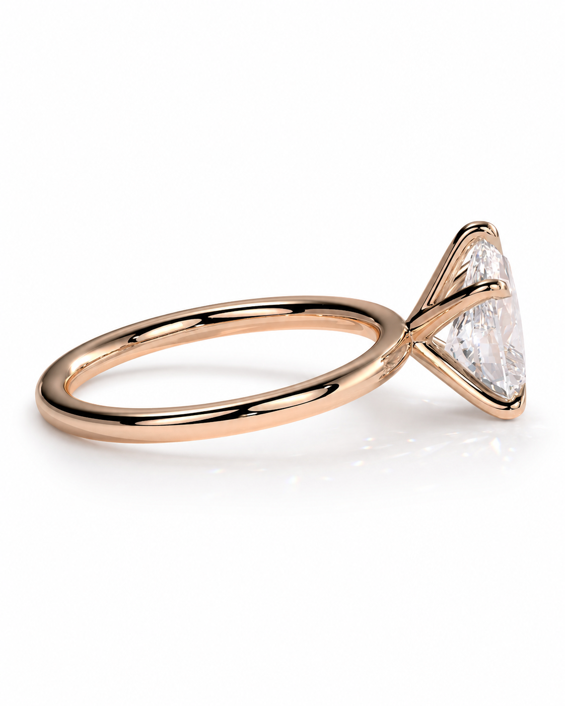 color_10K_RG, color_14K_RG &&
A rose gold ring with a triangular prong setting holding a clear, brilliant-cut gemstone, shown on a clean white background.