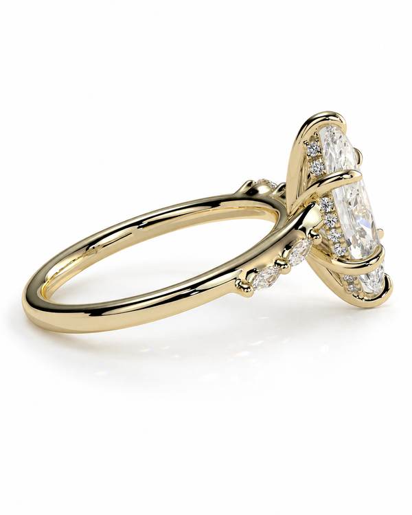 color_10K_YG, color_14K_YG &&A yellow gold ring featuring a large marquise-cut diamond center stone with smaller round diamonds in a halo and along the shank, shown on a clean white background.