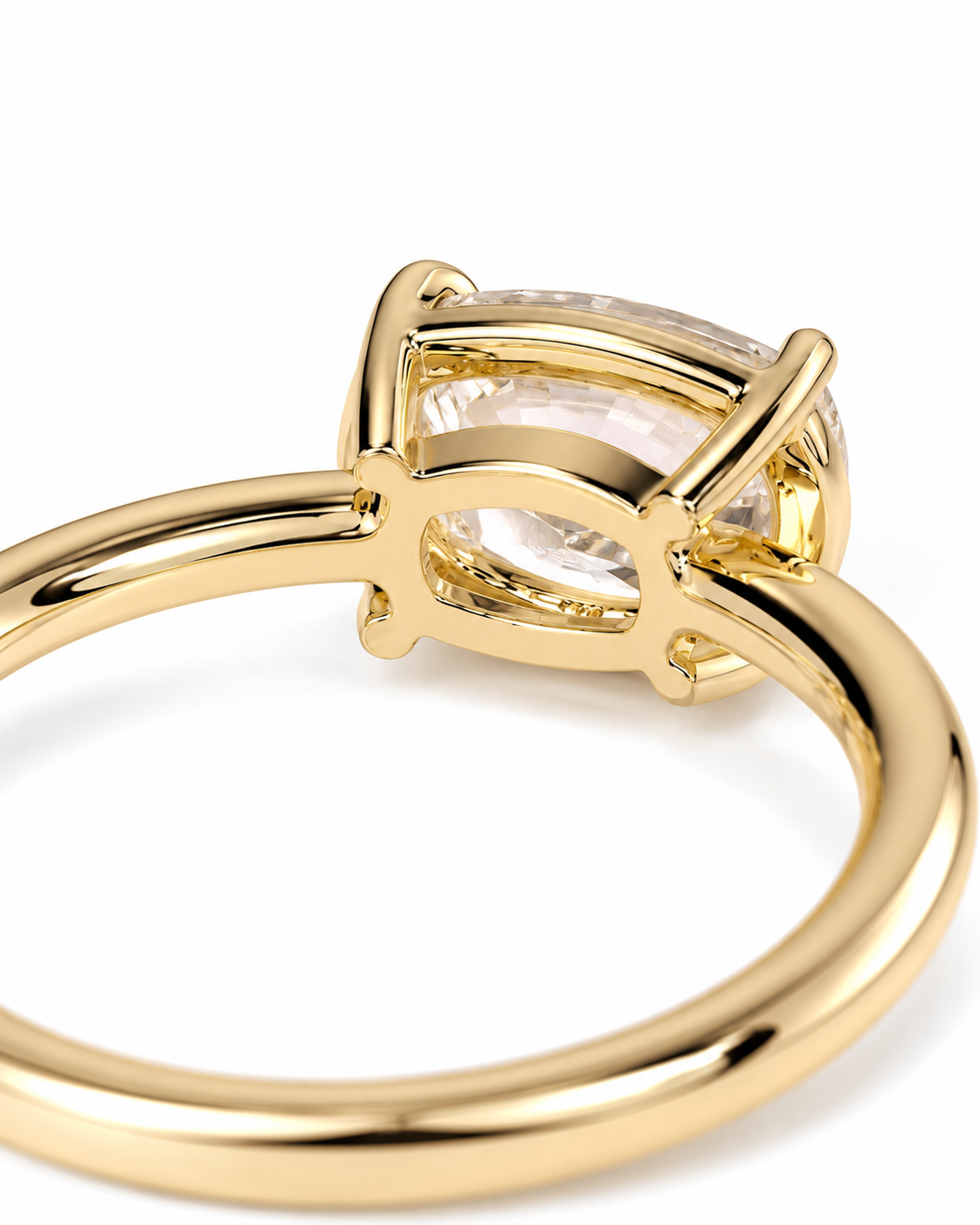 color_10K_YG, color_14K_YG &&A close-up shot of a gold ring featuring a large, clear cushion-cut gemstone in a four-prong setting, shown against a plain white background.