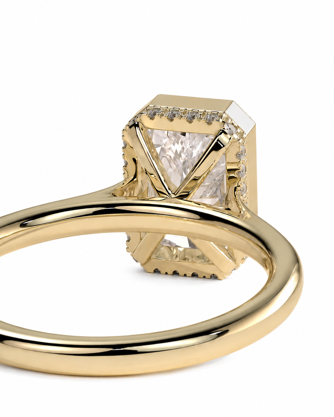 color_10K_YG, color_14K_YG &&A close-up shot of a gold ring featuring a large square-cut clear gemstone in a geometric setting, with smaller accent stones along the sides, on a plain white background.