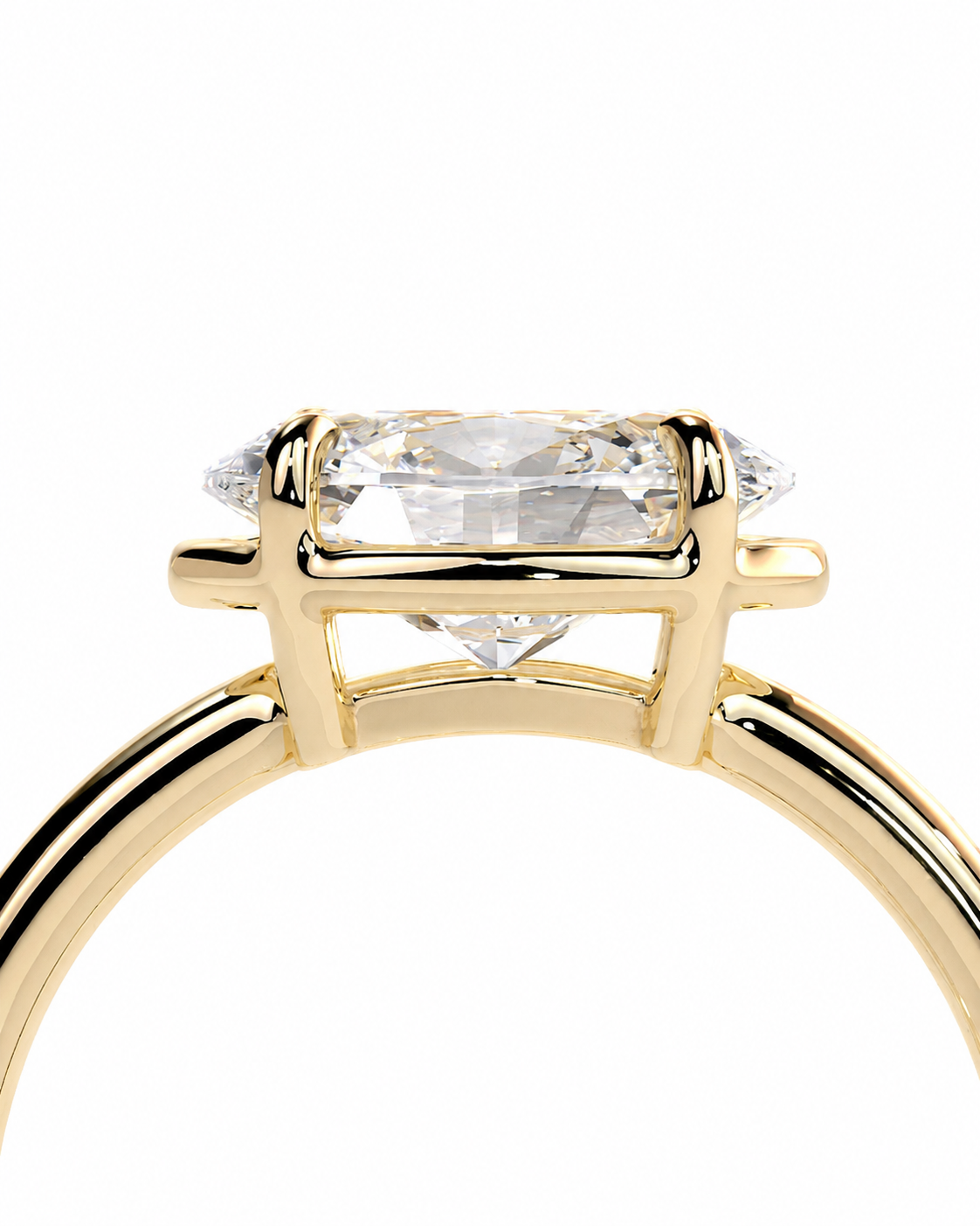 color_10K_YG, color_14K_YG &&A close-up of a yellow gold ring featuring a large rectangular clear gemstone in a four-prong setting, with smaller side stones, on a plain white background.