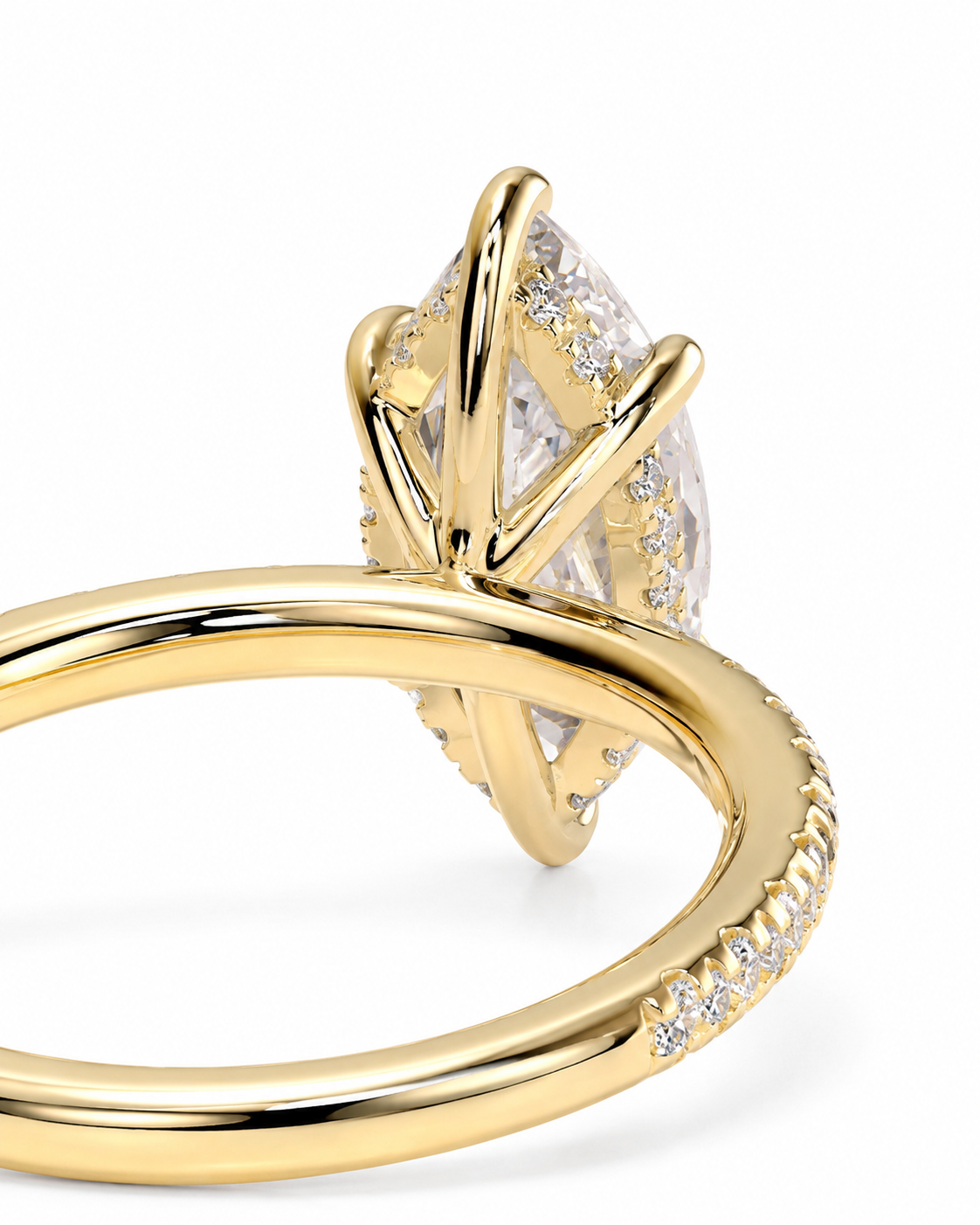 color_10K_YG, color_14K_YG &&A close-up shot of a yellow gold ring featuring a marquise-cut clear gemstone in a prong setting, accented with small pavé diamonds on the band, set against a clean white background.