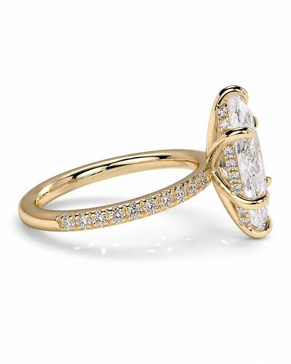 color_10K_YG, color_14K_YG &&A yellow gold ring featuring a large marquise-cut clear center stone and smaller pavé-set diamonds along the band, shown on a clean white background.
