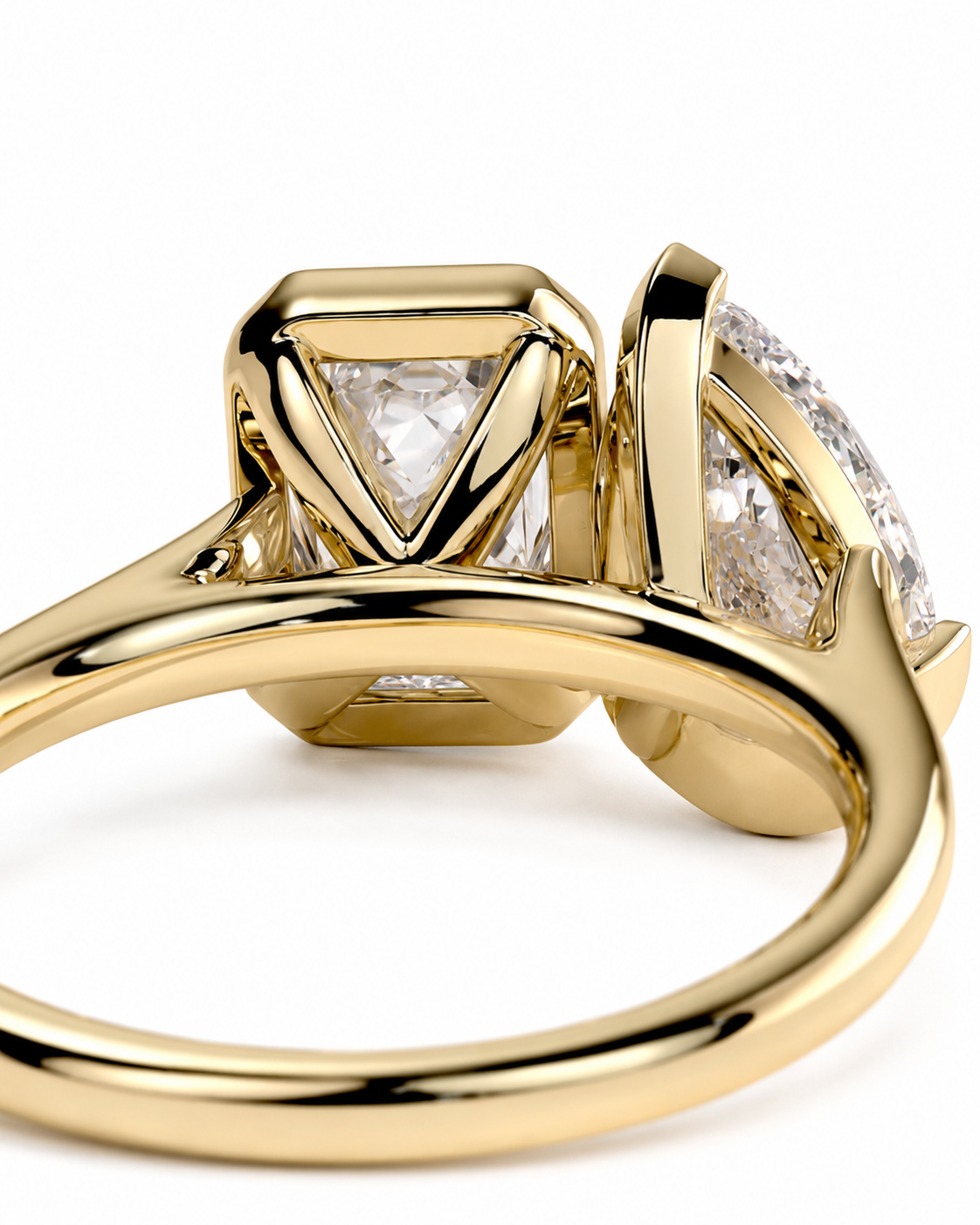 color_10K_YG, color_14K_YG &&A close-up of a yellow gold ring featuring a triangular-cut clear gemstone and a marquise-cut clear gemstone in a split-shank setting, shown on a white background.