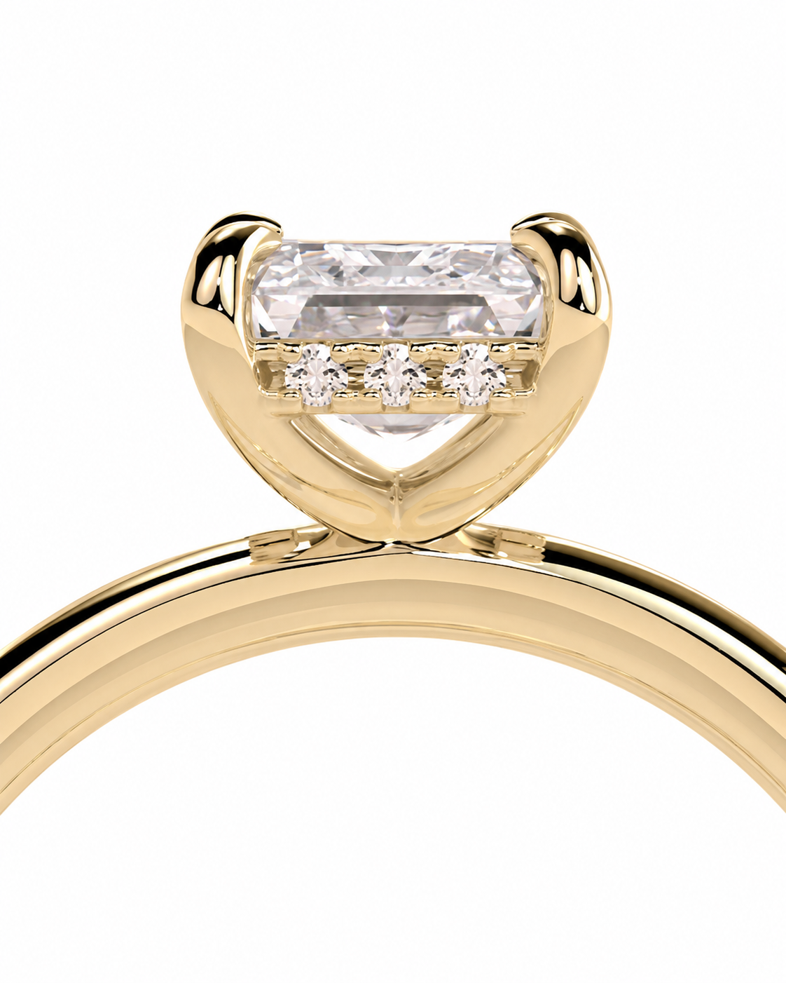 color_10K_YG, color_14K_YG &&
A close-up of a yellow gold ring featuring a large rectangular clear center stone and three small round stones in a row beneath the main setting, shown on a plain white background.