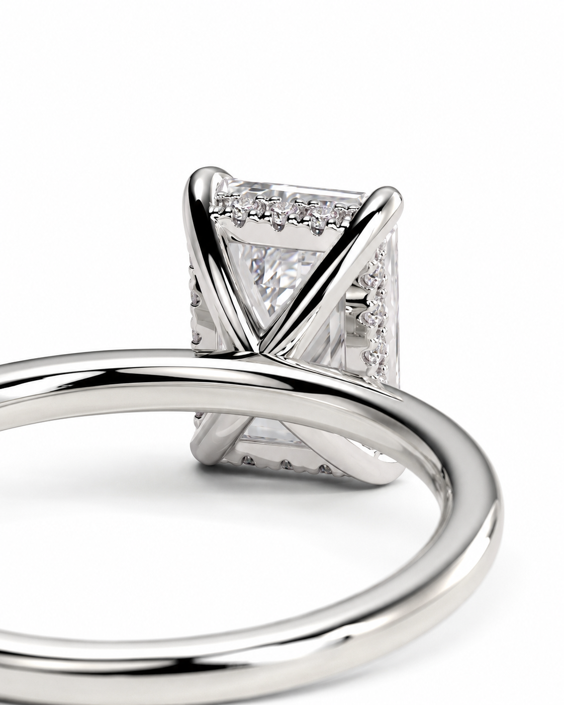 color_925_SIL,color_935_ARG,color_10K_WG, color_14K_WG &&
Close-up of a silver-toned ring featuring a rectangular clear gemstone in a four-prong setting with small accent stones along the sides, shown on a white background.
