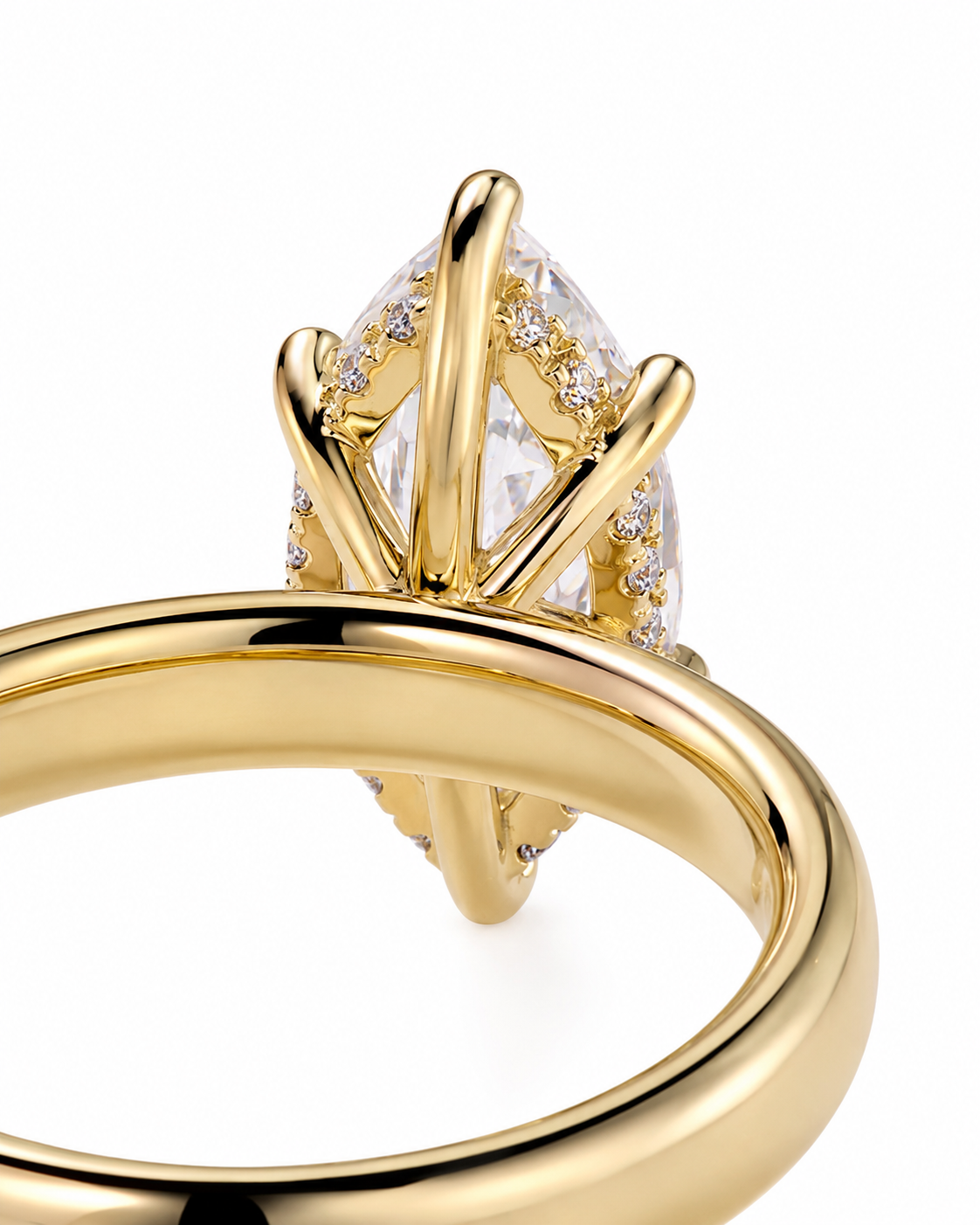 color_10K_YG, color_14K_YG &&A close-up of a yellow gold ring featuring a marquise-cut clear gemstone in a crown-like prong setting, accented with small round diamonds, on a white background.