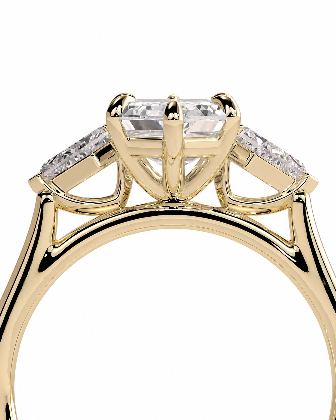 color_10K_YG, color_14K_YG &&A close-up shot of a yellow gold ring featuring a large rectangular center stone and smaller side stones, set against a plain white background.