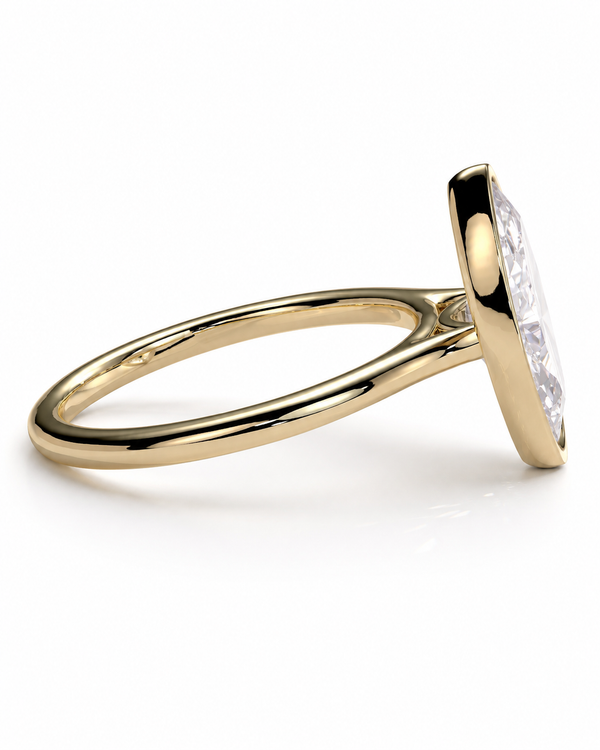 color_10K_YG, color_14K_YG &&A yellow gold ring with a bezel-set clear marquise-cut gemstone, shown from a side angle on a clean white background.