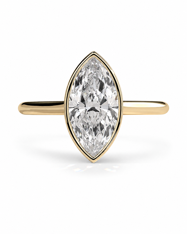color_10K_YG, color_14K_YG &&A yellow gold ring featuring a marquise-cut clear gemstone in a bezel setting, shown against a plain white background.