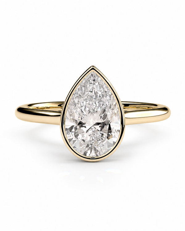 color_10K_YG, color_14K_YG &&A pear-cut diamond engagement ring in a yellow gold setting with a slim gold band, shown on a clean white background.
