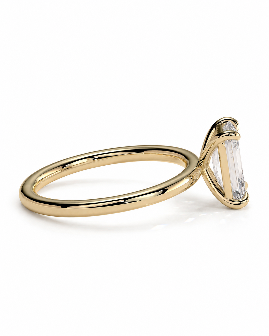 color_10K_YG, color_14K_YG &&
A gold ring with a tapered baguette-cut clear gemstone in a prong setting, shown from a side angle on a clean white background.
