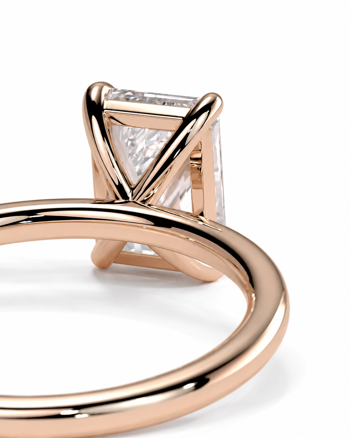 color_10K_RG, color_14K_RG &&
Close-up of a rose gold ring with a rectangular clear gemstone in a Y-prong setting, shown on a white background.