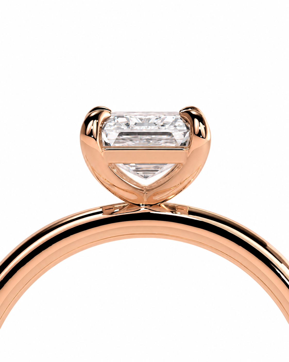 color_10K_RG, color_14K_RG &&
A close-up of a rose gold ring featuring a heart-shaped bezel setting with a rectangular clear gemstone, shown against a solid white background.