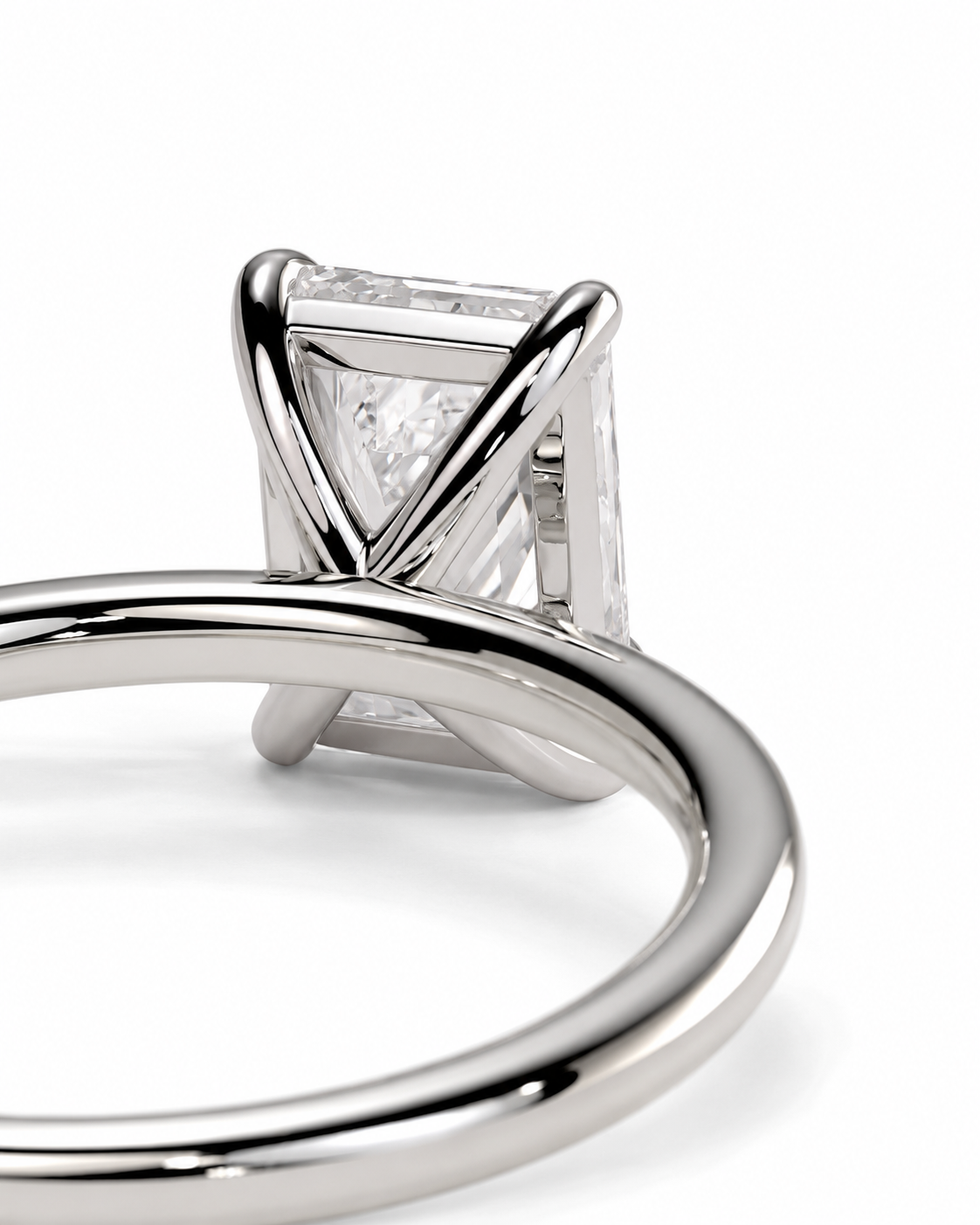 color_925_SIL,color_935_ARG,color_10K_WG, color_14K_WG &&
Close-up of a silver-toned ring with a rectangular clear gemstone in a twisted prong setting, shown on a white background.