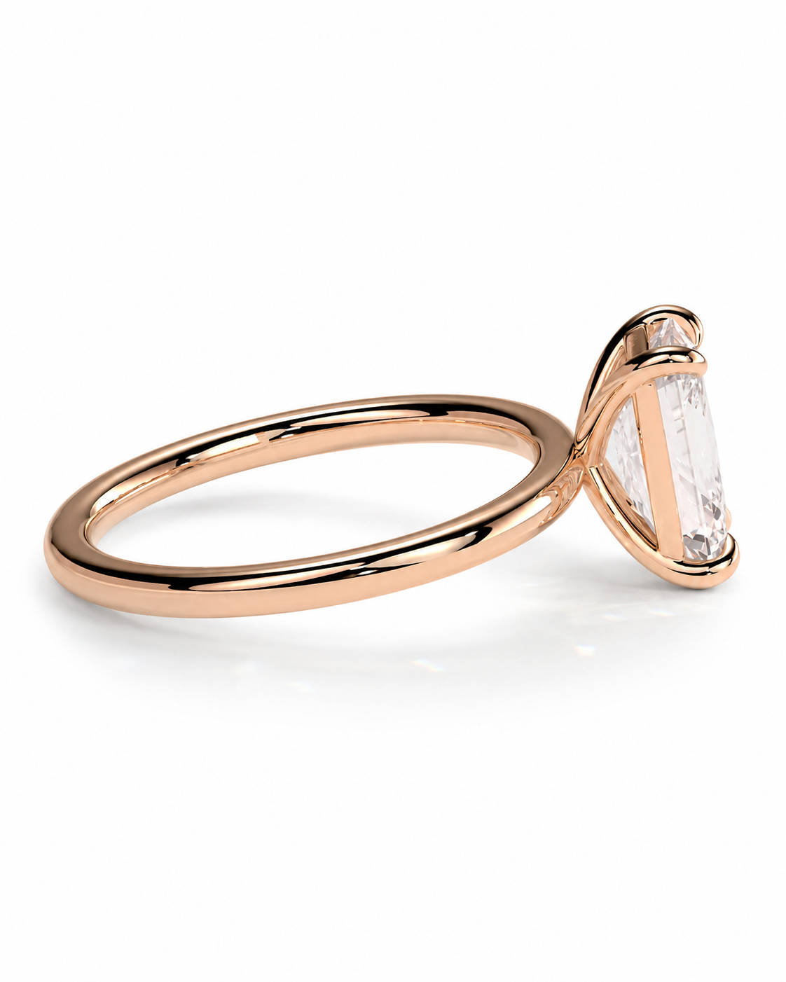 color_10K_RG, color_14K_RG &&
A rose gold ring with a single baguette-cut clear gemstone in a prong setting, shown on a clean white background.