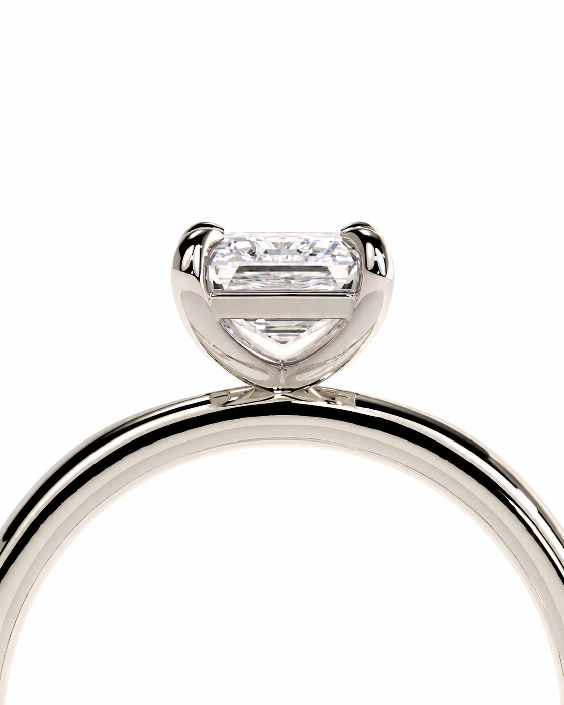 color_925_SIL,color_935_ARG,color_10K_WG, color_14K_WG &&
A close-up studio shot of a silver-toned ring featuring a baguette-cut clear gemstone in a prong setting, shown against a plain white background.
