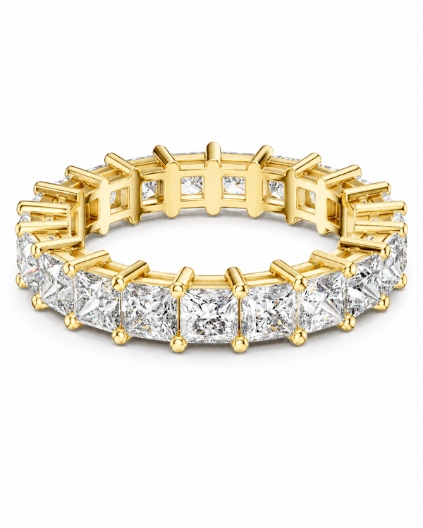 color_10K_YG, color_14K_YG &&	
A yellow gold eternity ring featuring a continuous row of princess-cut clear diamonds in a prong setting, shown on a clean white background.
