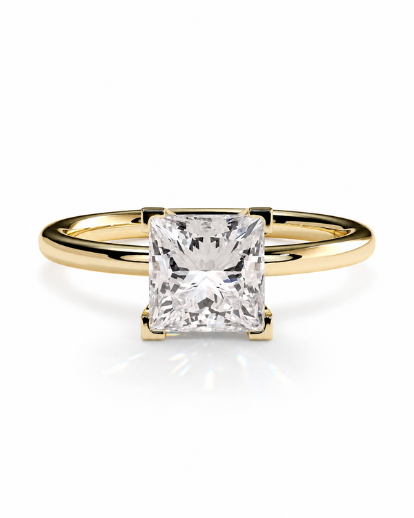 color_10K_YG, color_14K_YG &&A yellow gold solitaire engagement ring featuring a large, square princess-cut clear diamond in a four-prong setting, shown on a clean white background with a soft reflection.