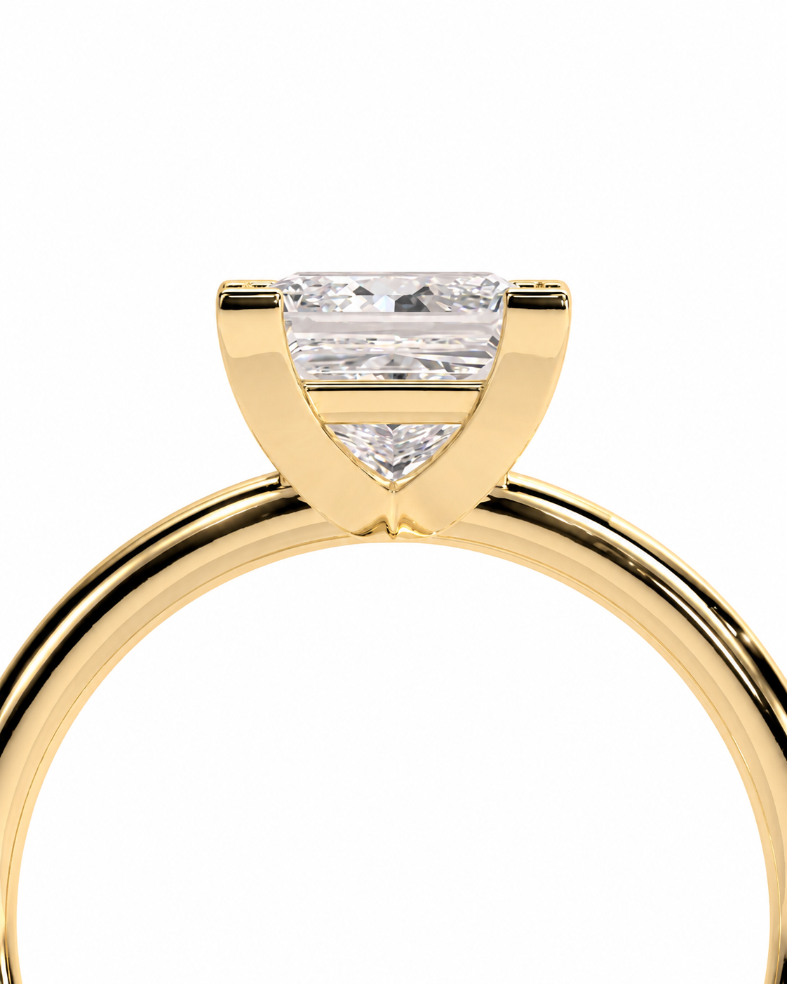 color_10K_YG, color_14K_YG &&A close-up of a yellow gold ring featuring a rectangular baguette-cut diamond and a small triangular diamond set in a Y-prong setting, shown against a solid white background.