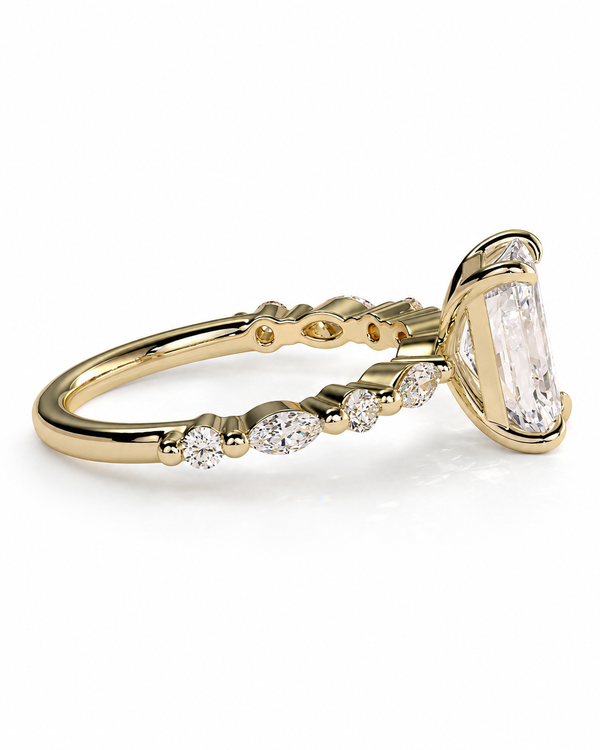 color_10K_YG, color_14K_YG &&A yellow gold ring featuring a large rectangular baguette-cut clear gemstone in a prong setting, with smaller marquise and round-cut clear stones along the band, shown on a white background.