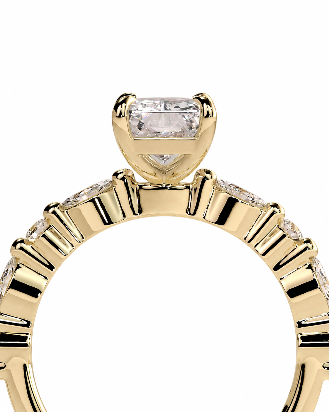 color_10K_YG, color_14K_YG &&A close-up of a yellow gold ring featuring a rectangular baguette-cut clear center stone in a prong setting, with a row of small round stones along the band, shown against a plain white background.