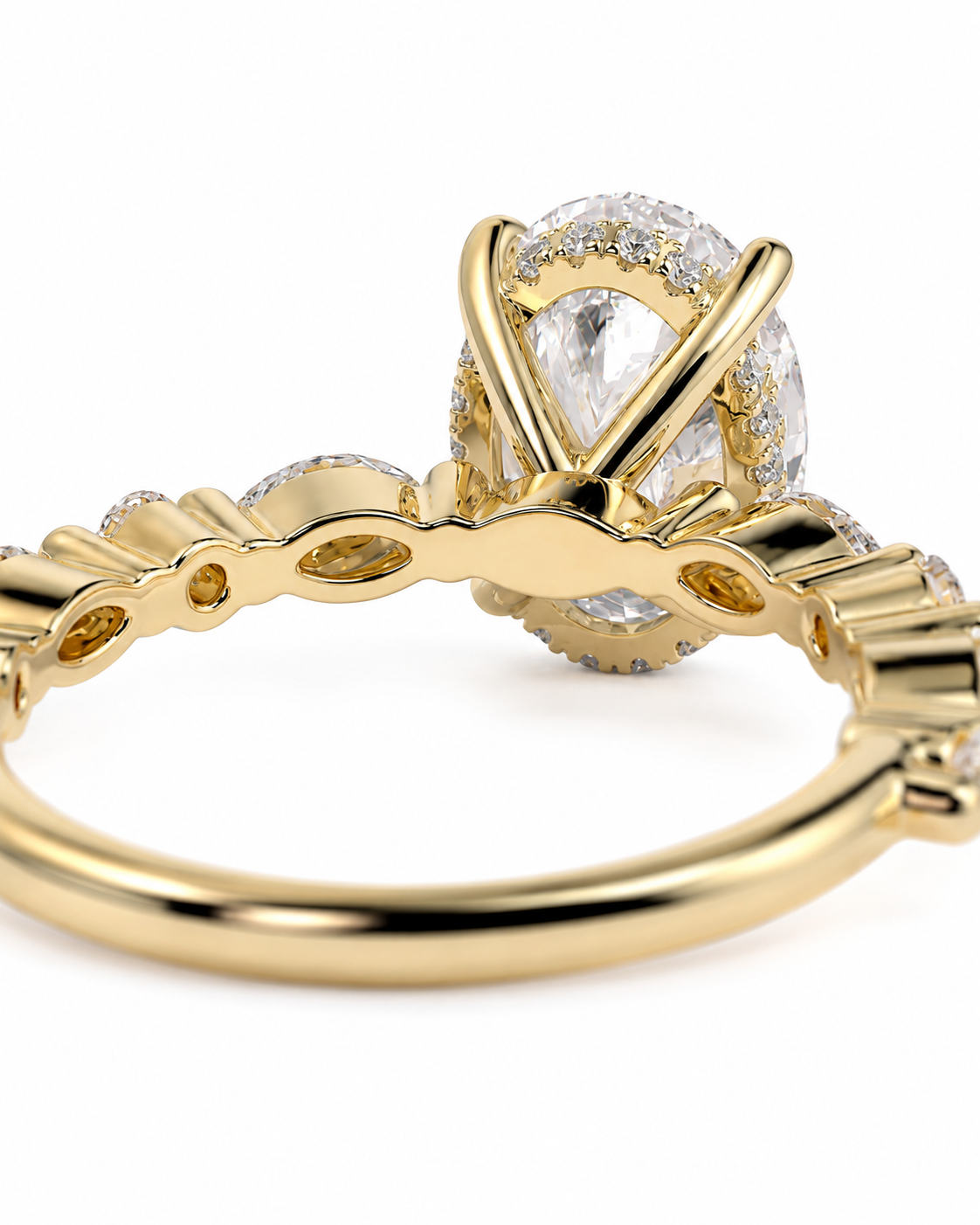 color_10K_YG, color_14K_YG &&A close-up of a yellow gold ring featuring a large oval clear gemstone in a prong setting, with smaller accent stones along the band, shown on a white background.