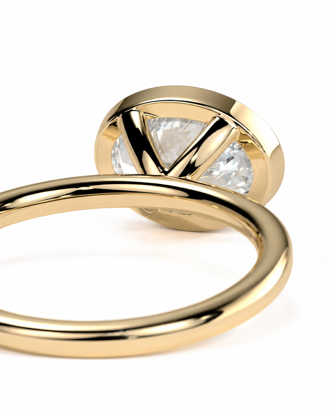 color_10K_YG, color_14K_YG && close-up of a gold ring with a round bezel setting holding a clear triangular-cut gemstone, shown on a white background.