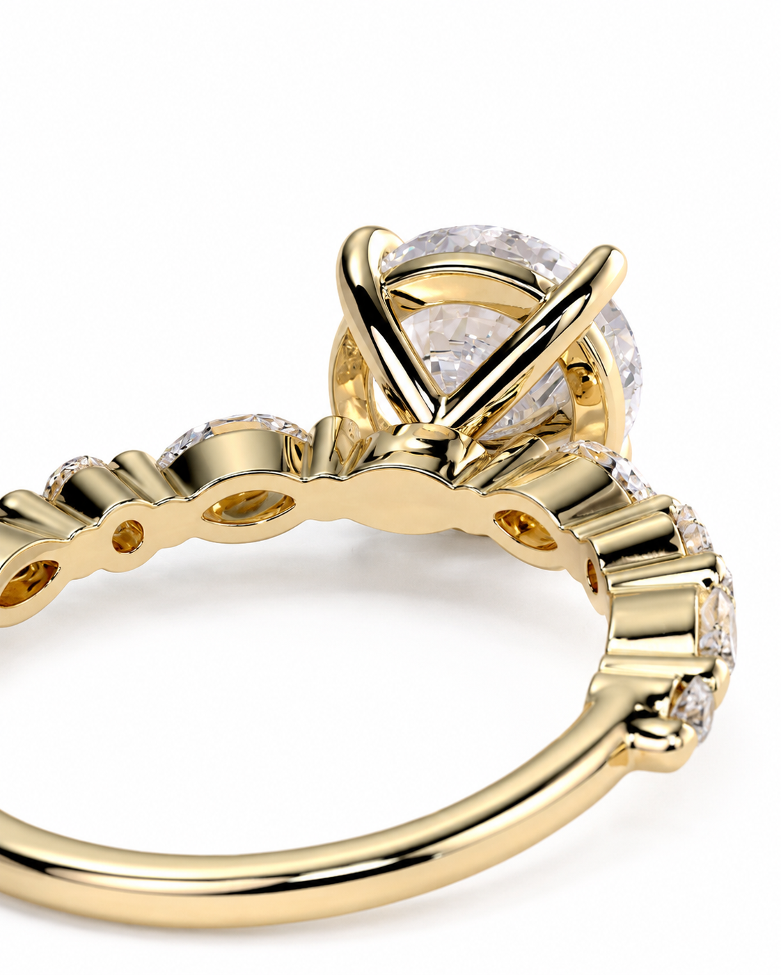 color_10K_YG, color_14K_YG &&A close-up of a yellow gold ring featuring a large round clear gemstone in a prong setting, with smaller clear stones along the band, shown on a white background.