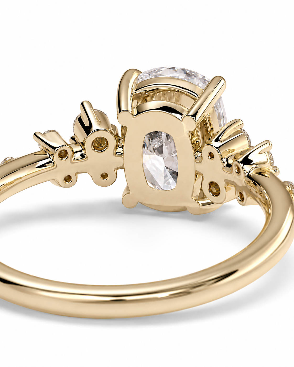 color_10K_YG, color_14K_YG &&A close-up of a yellow gold ring featuring a large oval clear gemstone in a decorative setting with smaller accent stones on the band, set against a plain white background.