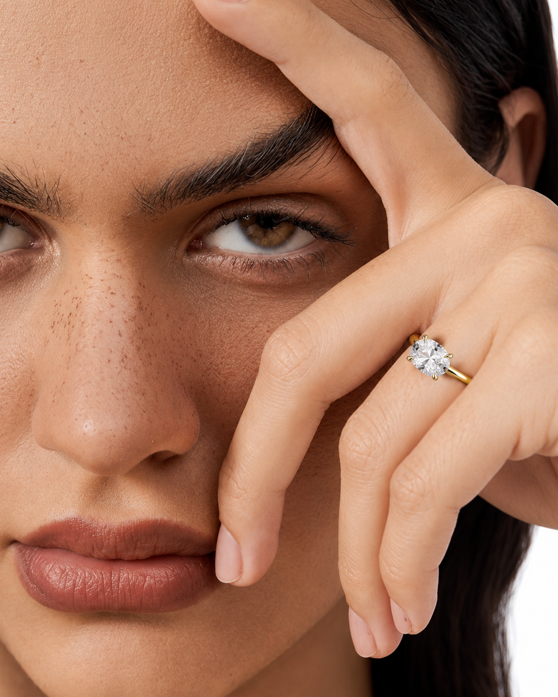 color_10K_YG, color_14K_YG &&
A close-up lifestyle shot of a model wearing a yellow gold ring with a four-petal flower setting and a clear central gemstone.