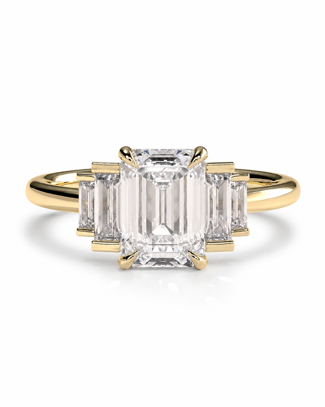 color_10K_YG, color_14K_YG &&A yellow gold ring featuring a large emerald-cut center stone flanked by three smaller baguette-cut side stones, set against a clean white background.