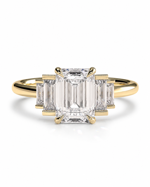 color_10K_YG, color_14K_YG &&A yellow gold ring featuring a large emerald-cut center stone flanked by three smaller baguette-cut side stones, set against a clean white background.