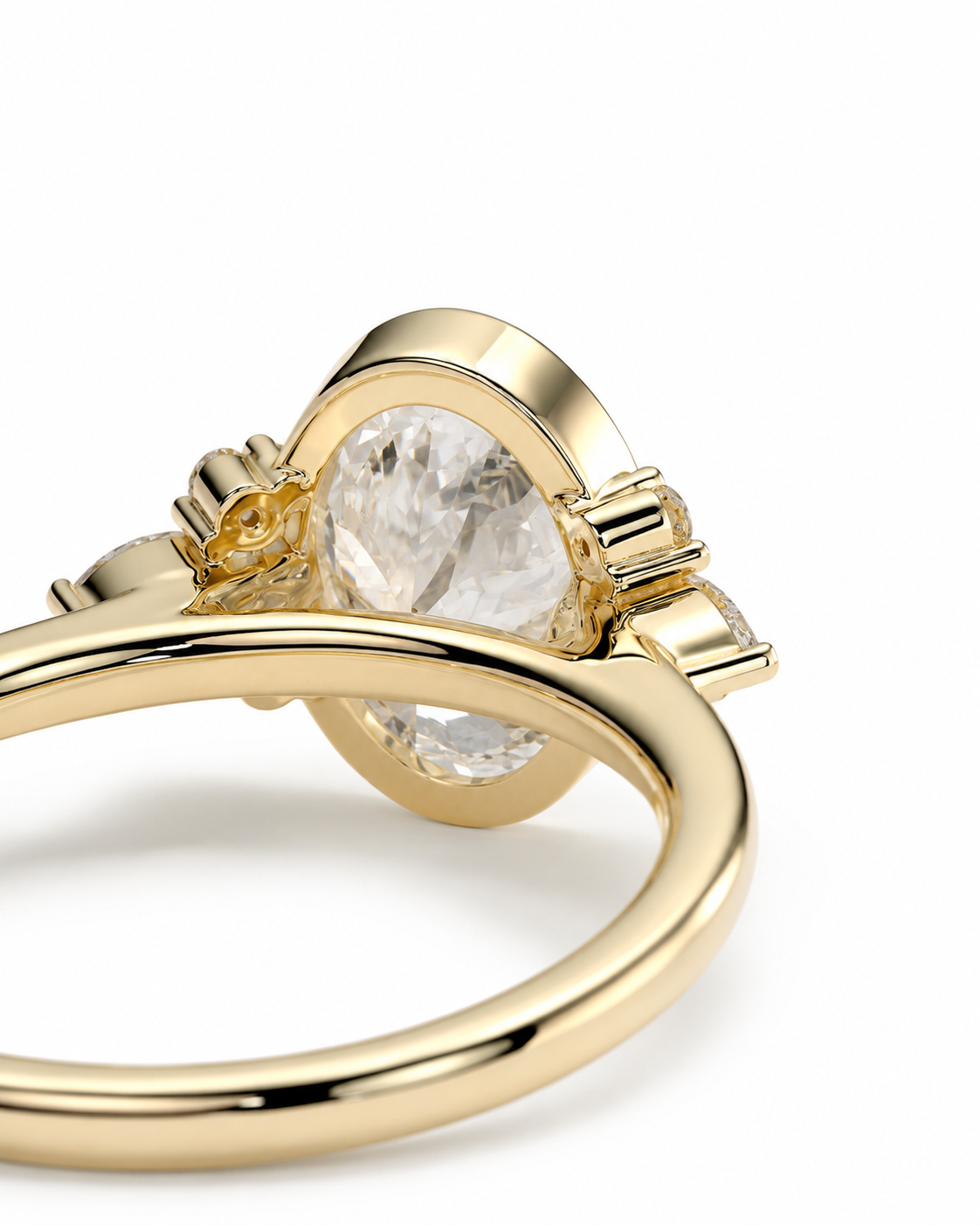 color_10K_YG, color_14K_YG &&A close-up shot of a gold ring featuring a large oval clear gemstone in a polished bezel setting, with smaller accent stones on either side, photographed on a clean white background.