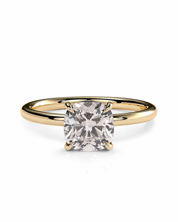 color_10K_YG, color_14K_YG &&A yellow gold solitaire engagement ring featuring a cushion-cut clear gemstone in a four-prong setting, shown on a clean white background.