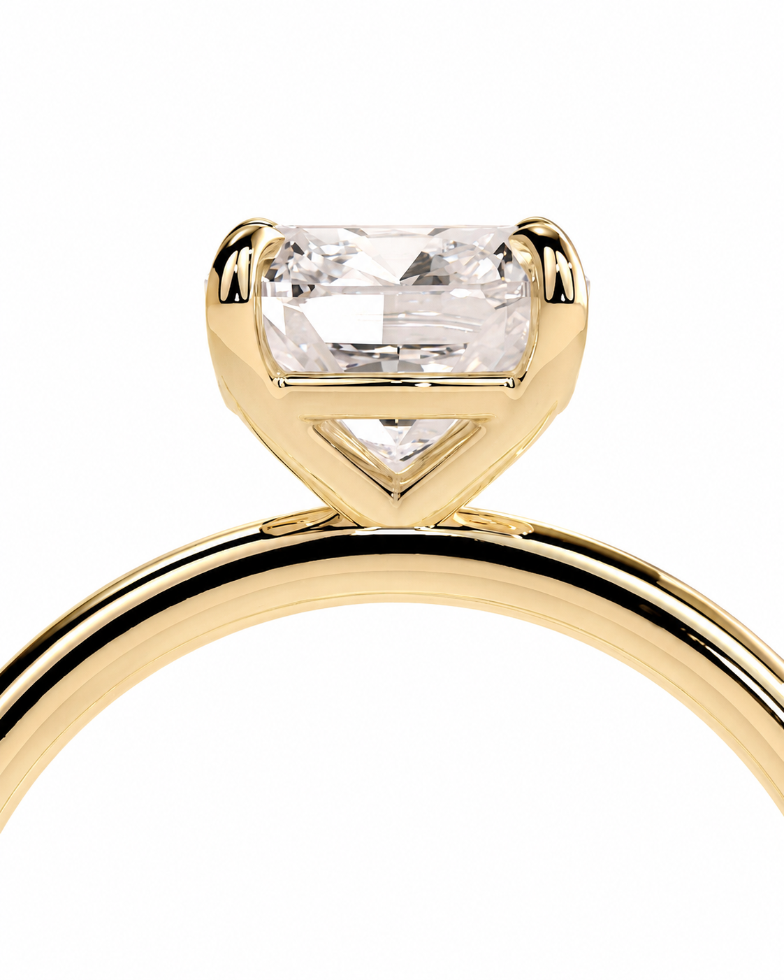 color_10K_YG, color_14K_YG &&A close-up of a yellow gold ring featuring a rectangular clear gemstone in a prong setting, shown against a plain white background.
