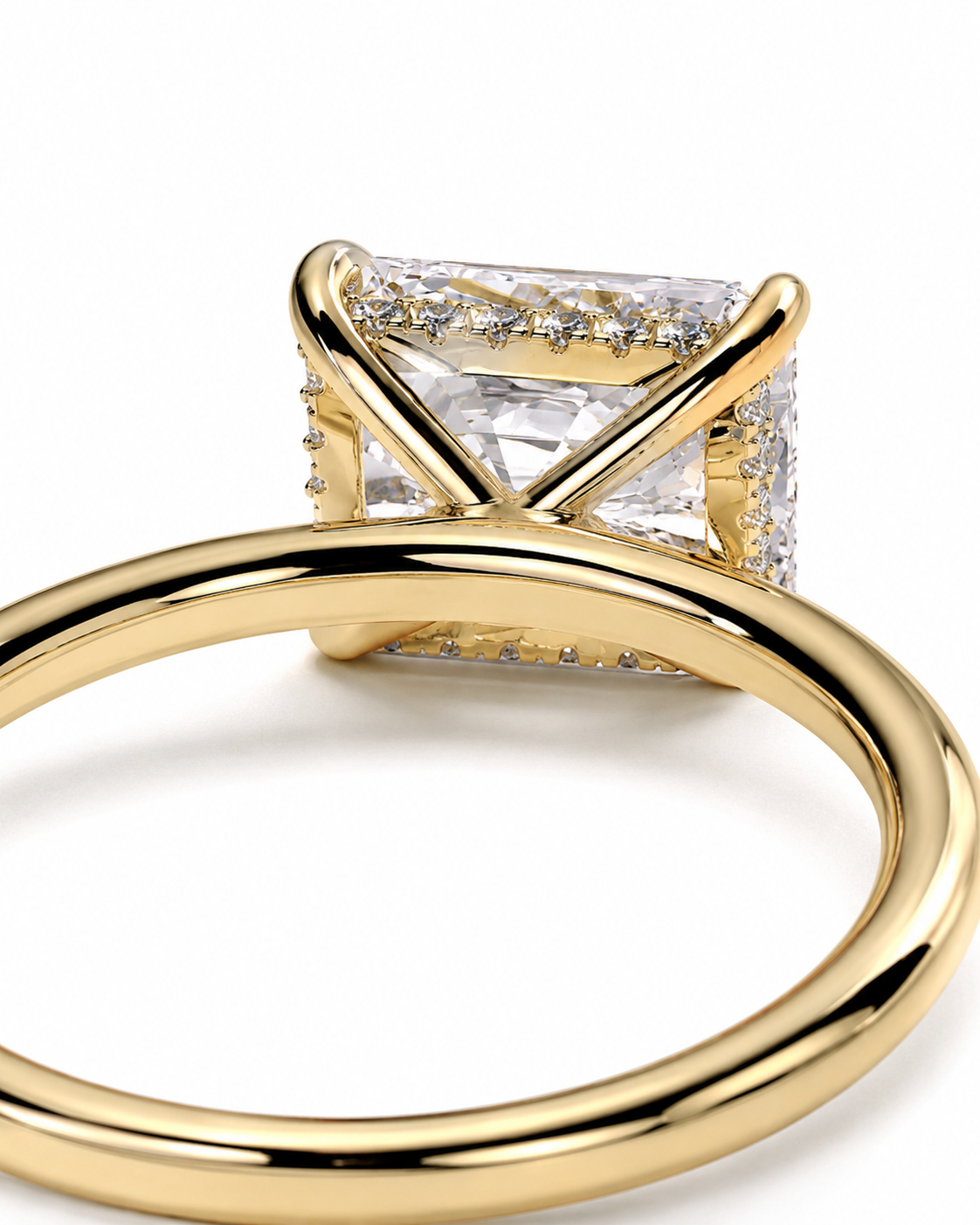 color_10K_YG, color_14K_YG &&A close-up shot of a yellow gold ring featuring a large rectangular clear gemstone in a prong setting with small accent stones along the sides, on a white background.