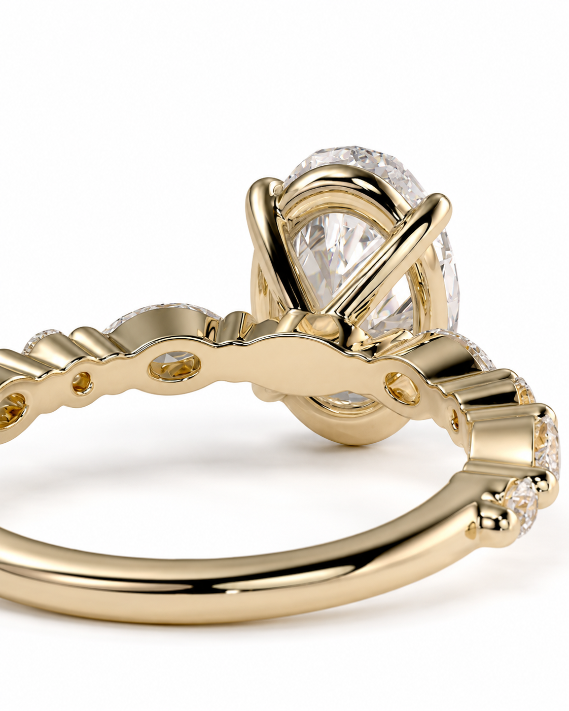 color_10K_YG, color_14K_YG &&
A close-up of a yellow gold ring featuring a large oval clear gemstone in a prong setting, with smaller accent stones along the band, shown on a white background.