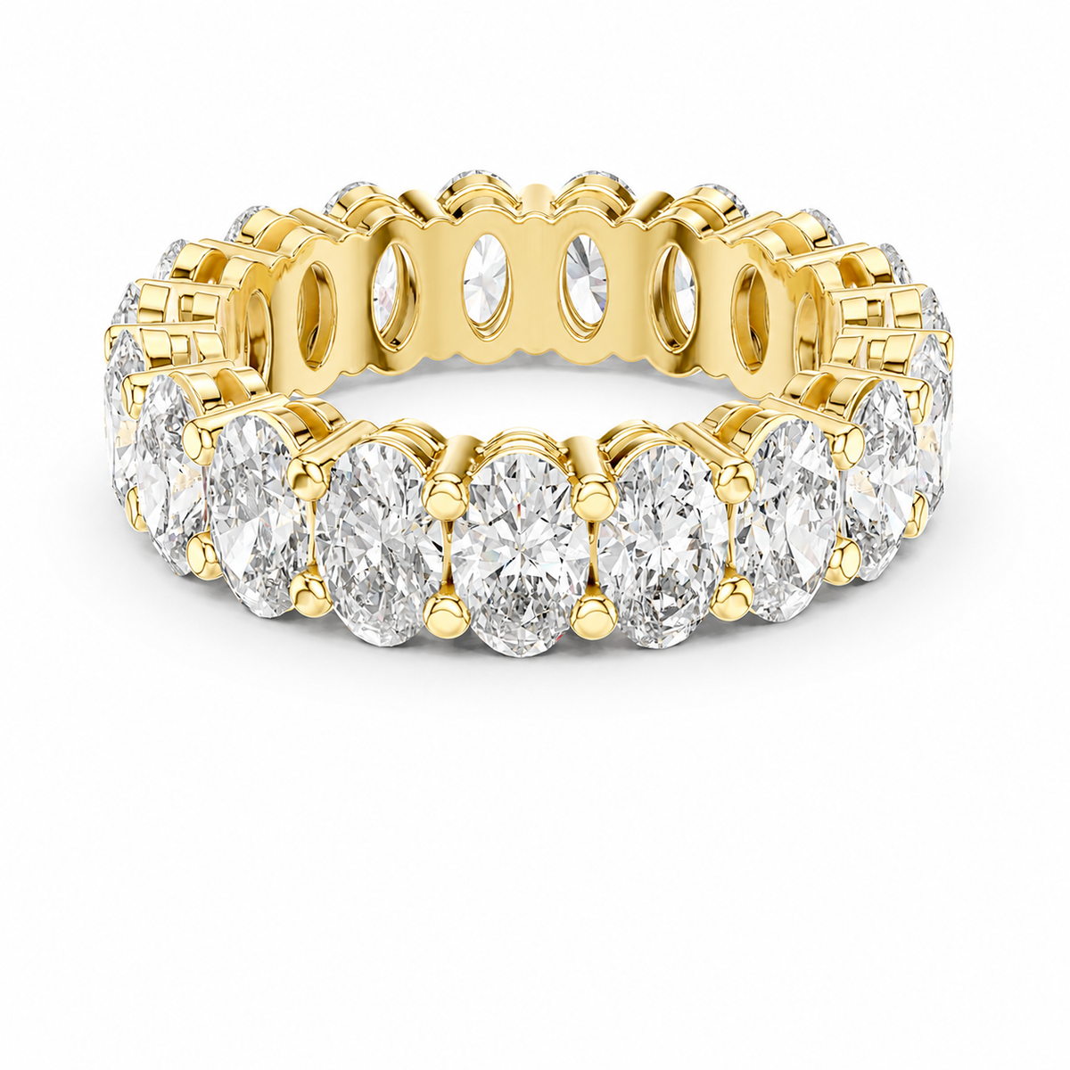 color_10K_YG, color_14K_YG &&	
A yellow gold eternity ring featuring a continuous row of oval-cut clear gemstones in a prong setting, shown on a clean white background.